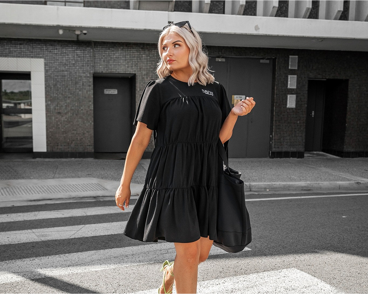 woman crossing the road wearing savvy industry clothing