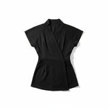SOHO Wrap top in black bleach-resistant fabric, flat lay