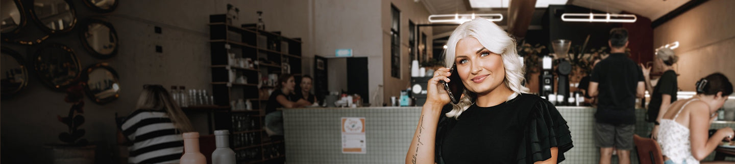 woman wearing savvy industry clothing while calling in the phone