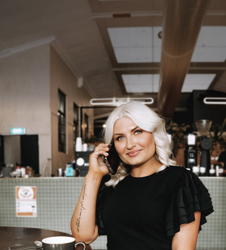woman wearing savvy industry clothing while calling in the phone